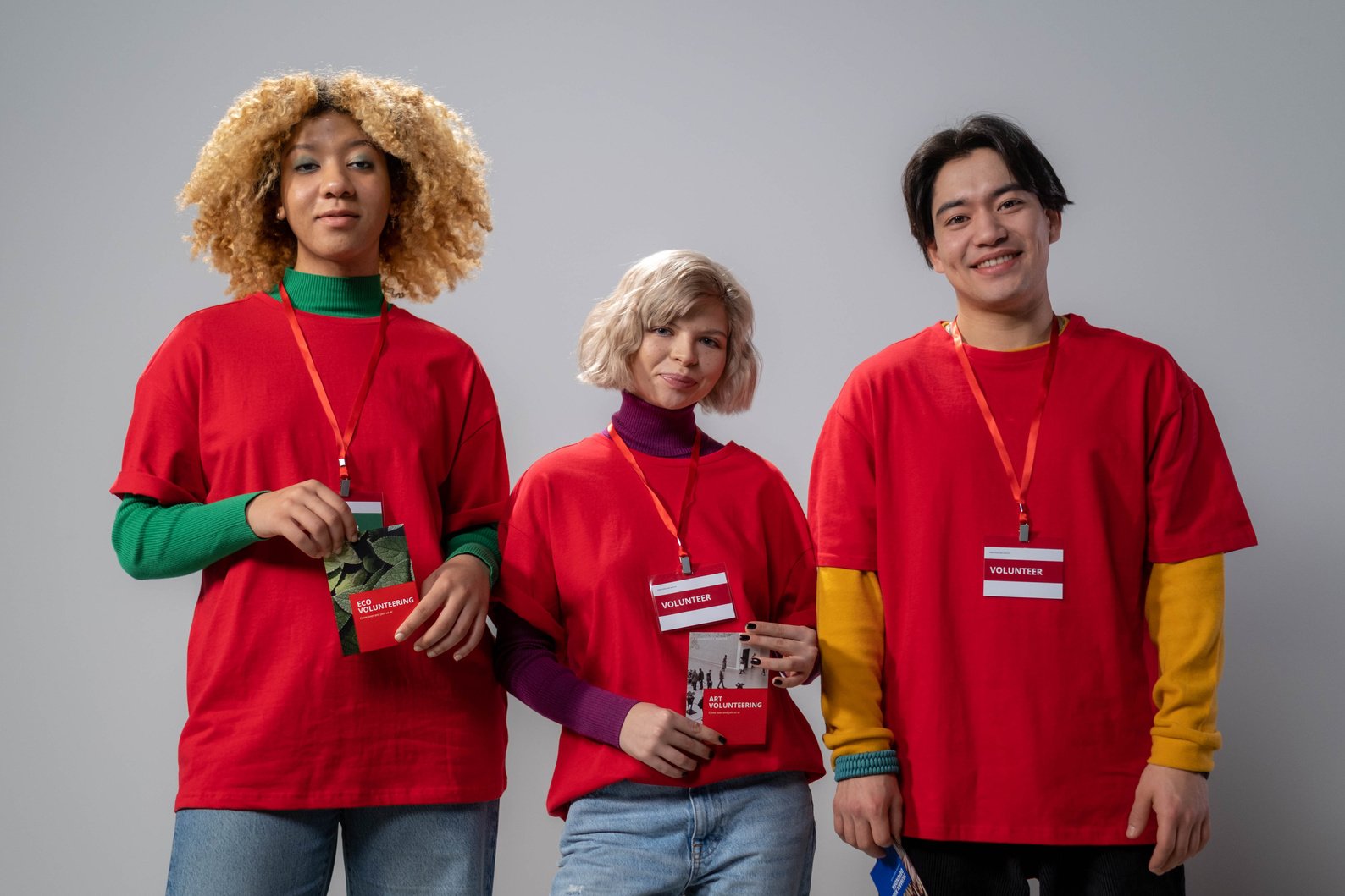 People in Red Shirts Wearing Volunteer Lanyards